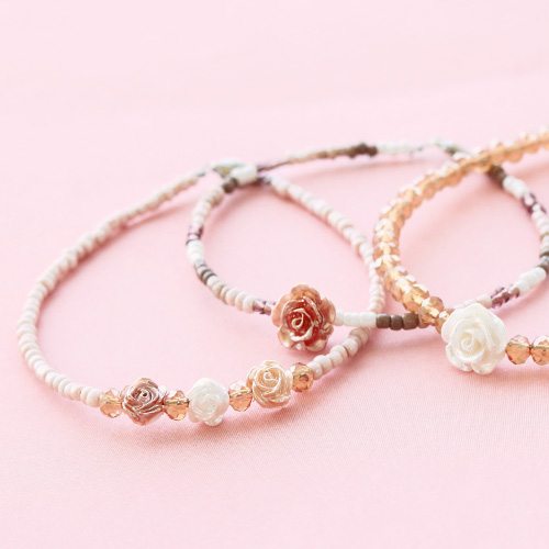 Minimalist flower jewellery with rose beads and daisy flower beads