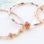 Minimalist flower jewellery with rose beads and daisy flower beads