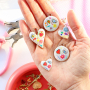 Create a funky charm necklace with metal charms with enamel